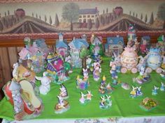 there are many figurines on the table in front of the wall behind it