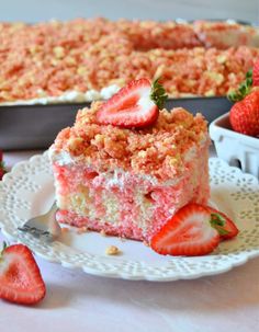 strawberry crunch poke cake on a plate with strawberries