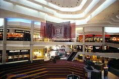 the inside of a shopping mall filled with lots of shops