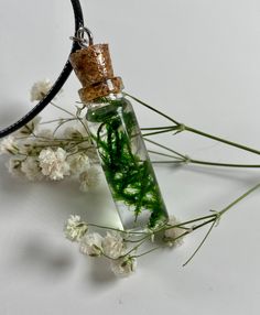 Introducing our Moss-in-a-Bottle Pendant - a wearable piece of nature's charm that encapsulates the tranquility of a miniature forest within a gracefully elongated, shatter-proof resin vessel. Inspired by the beauty of our Moss-in-a-Bottle Earrings, this pendant is a testament to the harmony between nature and jewelry craftsmanship. Crafted with meticulous detail, the pendant features real, vibrant green moss suspended in the crystal-clear resin, creating a mesmerizing and evergreen scene. The e Handmade Green Fantasy Jewelry, Handmade Magical Green Jewelry, Handmade Fairycore Jewelry Gift, Handmade Magical Style Green Jewelry, Bohemian Green Jewelry With Pressed Flowers, Whimsical Green Jewelry For Gifts, Fairycore Earrings, Earrings Cottagecore, Cottagecore Earrings