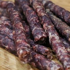 several sausages on a cutting board ready to be cooked