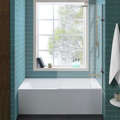 a white bath tub sitting next to a window