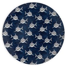 a blue and white plate with sharks on it