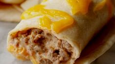 a burrito filled with meat and orange slices