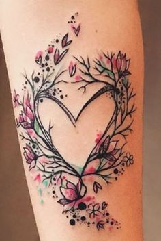 a heart shaped tattoo with flowers and leaves