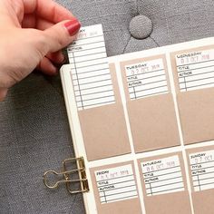 a hand holding a clipboard attached to a binder