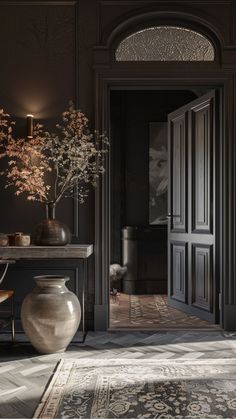 a vase with flowers in it sitting on the floor next to a table and chair