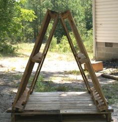 a wooden structure sitting in the middle of a yard