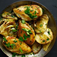 chicken and potatoes in a skillet with parsley