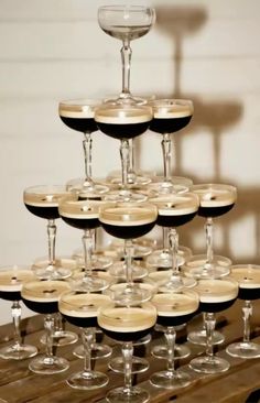 there are many wine glasses stacked on top of each other