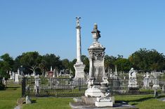 a cemetery with many headstones and statues