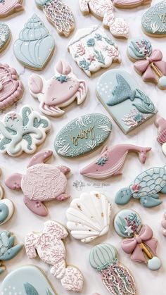 there are many decorated cookies in the shape of sea animals and fish on this table