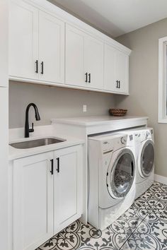 a washer and dryer in a white laundry room with black and white floor tiles