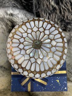 a decorative box sitting on top of a fur covered floor