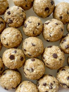 a white plate filled with cookies and oatmeal muffins on top of a table