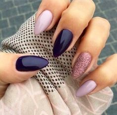 a woman's hands with purple and pink nail polish