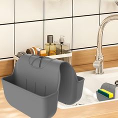 a kitchen sink with soap dispenser and sponge holder