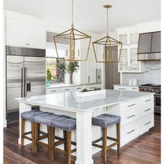 a kitchen island with two stools in front of it