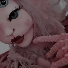 a close up of a doll with big eyes