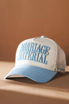 a white and blue hat with the words marriage material on it sitting on a table