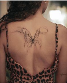 a woman with a butterfly tattoo on her back