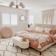 a bedroom with a large bed and white walls