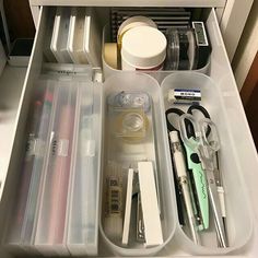 an organized drawer with scissors and other items