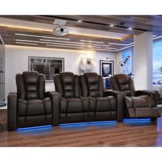 three reclining chairs in a room with wooden floors