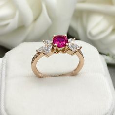 This beautiful ring is made from genuine 925 sterling silver with Rose Gold plating. Ring details- -The Main stone is a round cut 6mm Lab Created Ruby Stone -Side stones are 4mm by 2mm Marquise and 1mm Round simulated diamonds -Ring is casted in solid 925 sterling silver with Rose Gold plating ( Yellow Gold and White Rhodium plated also available, please check the drop down menu for more options) -The Total face height of the ring measures 7mms and the band width measures 1.5mms -Each ring is ha Promise Ruby Ring With Center Stone In Rose Gold, Rose Gold Ruby Ring With Center Stone For Promise, Pink Lab-created Ruby Promise Ring, Rose Gold Sterling Silver Ruby Promise Ring, Rose Gold Cluster Ring With Accent Stones For Promise, Rose Gold Birthstone Ring With Accent Stones For Promise, Rose Gold Birthstone Ring With Accent Stones, Rose Gold Ring With Lab-created Ruby, Rose Gold Rings With Lab-created Ruby