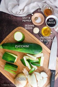 a cutting board topped with cucumbers, onions and seasonings