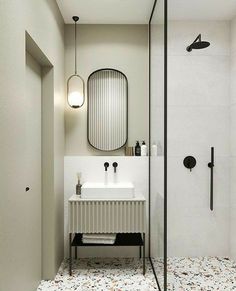 a bathroom with a shower, sink and mirror