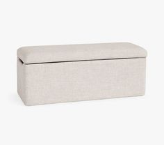 an upholstered storage box with a lid on the top and bottom, sitting against a white background