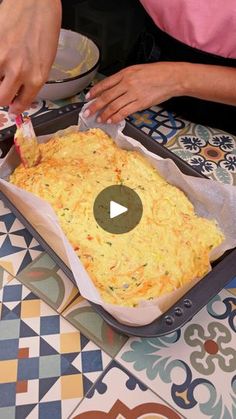 a person cutting food on top of a pan