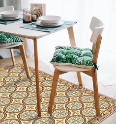 a table with two chairs and a place mat on the floor in front of it