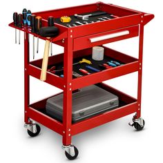 a red workbench with tools on the top and two drawers below it,