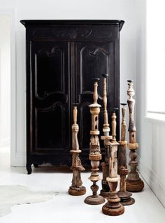 an armoire with many pieces of wood on it in front of a white wall