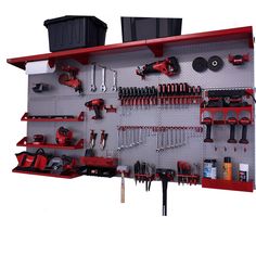 a wall mounted tool rack filled with tools