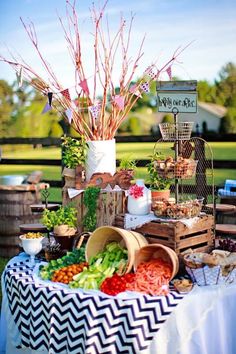 a table topped with lots of food next to a wooden barrel filled with eggs and vegetables