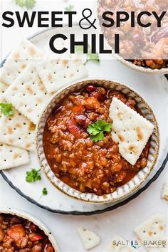 two bowls filled with chili and pita chips