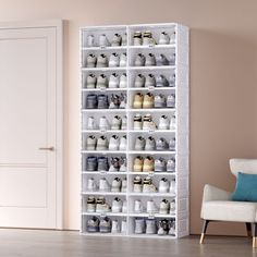 a room with a white chair and shelves filled with cups on the floor, in front of a door