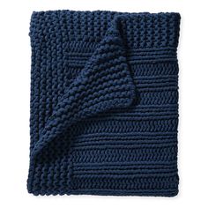 a blue knitted blanket folded on top of each other