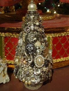 a silver christmas tree sitting on top of a table