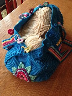 a crocheted purse sitting on top of a wooden table