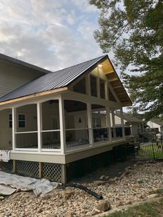 a house with a metal roof and covered porch