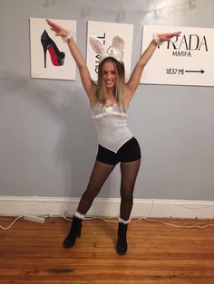 a woman in bunny ears and tights posing for the camera with her hands up