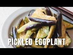 pickled eggplant on a white plate with chopsticks