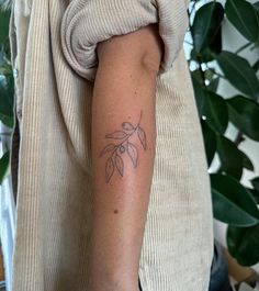 a woman with a tattoo on her arm