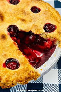 a close up of a pie on a plate with a piece missing from it's crust