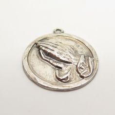 Has an engraving, but can be removed by a local jeweler. 925 Sterling Silver Vintage Hands in Prayer Charm Pendant Weight: 5.5g WELCOME TO PAWN SHOP We are an actual pawn shop and have been in business for over 25 years. Since 1990, our establishment has been serving a variety of clients by providing them with short term cash solutions and options of liquidity regarding their treasured heirlooms. Acknowledging that today′s customers are very sophisticated and are looking for a variety of investm Sterling Silver Spiritual Jewelry For Memorial, Spiritual 925 Stamped Jewelry For Memorials, Nickel Free Medallion Jewelry For Commemoration, Antique Silver Nickel-free Jewelry, Antique Nickel-free Silver Jewelry, Silver Coin Jewelry Stamped 925, Sterling Silver Coin Shaped Jewelry, Sterling Silver Charms Jewelry For Memorial, Silver Coin-shaped 925 Stamped Jewelry