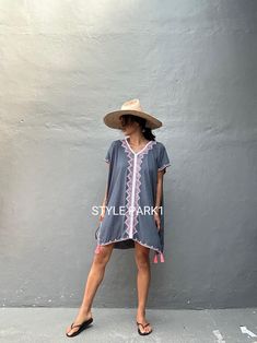 🙏🏻 please read measurement inch:Cm🙏🏻 This is a light soft comfy beautiful kaftan maxi dress. It is made of light soft Rayon  The dress  embroidery detail and tassel  Kaftan dress is perfectly in tune with the season's bohemian mood but is also a timeless choice for summer.  Photo -Model  size  Tall / 174cm /5.7 ft. Size fit - Medium Kaftan Dress size: USA /S~ L (one size) Color- Gray -tassel- Length - front& Back 92cm/36.22inch/3.01ft               Chest/140cm /55inch 4.59ft)round) 👉Dress i Hippie V-neck Cover-up For Vacation, Short Sleeve Beach Dress For Festival Season, Summer Boho Dress With V-neck And Tassel Ties, Summer Boho V-neck Dress With Tassel Ties, Beach Season Festival Dress With Short Sleeves, Short Sleeve Beach Dress For Beach Season Festivals, Vacation V-neck Kaftan With Tassel Ties, Casual Boho Dress With Tassels For Vacation, Beach Dresses With Short Sleeves And Tassels